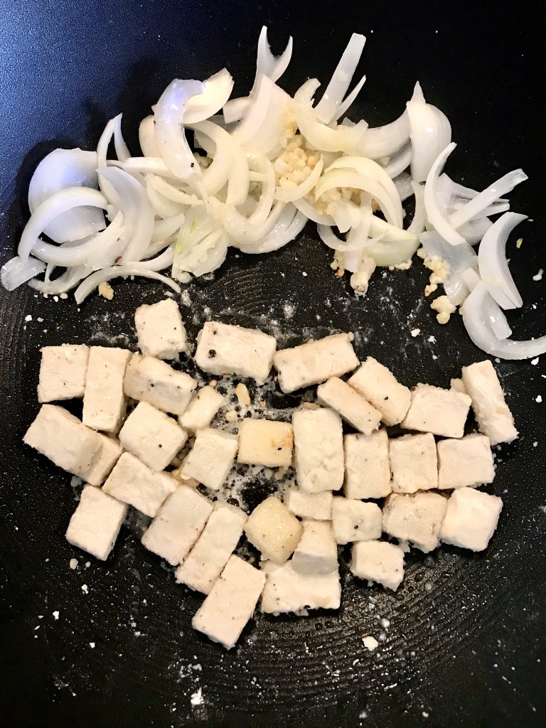 onion, garlic, and tofu stir frying