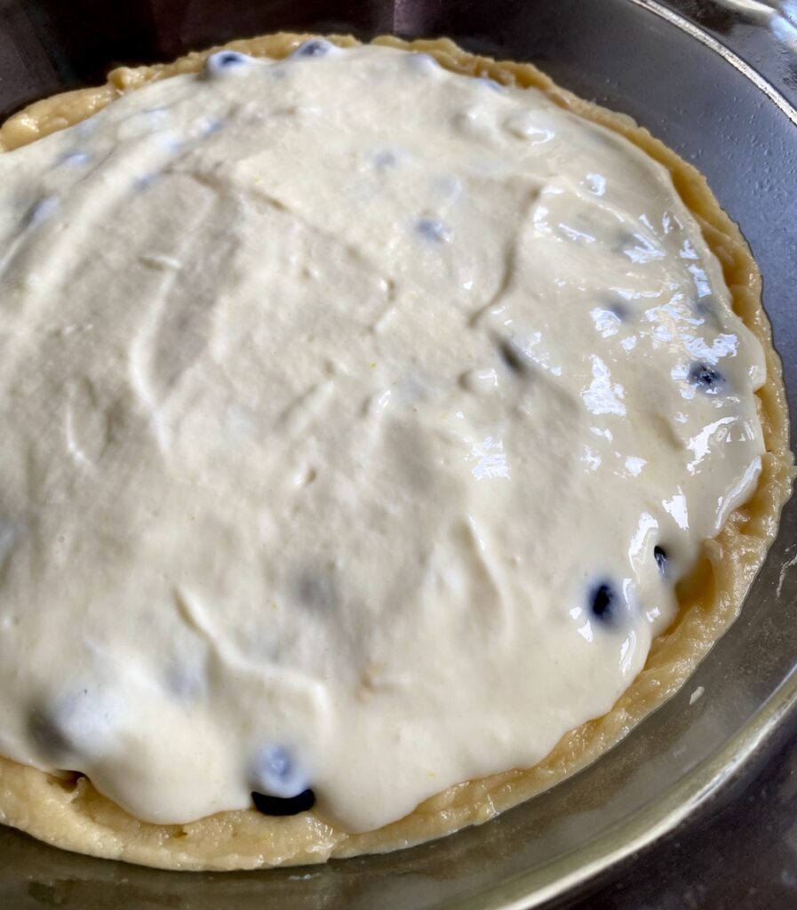 spreading pie crust filling into pie